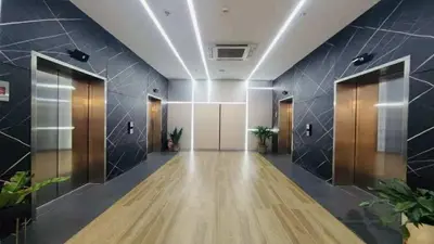 an office lobby with a hallway with doors and plants at AMA Tower Residences - Liam Kyro Staycation Place in Manila