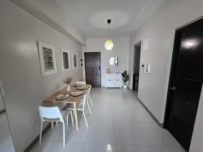 a kitchen and dining room with a table and chairs at Modern Comfort & Snap Worthy with Pool, Gym & More in Manila