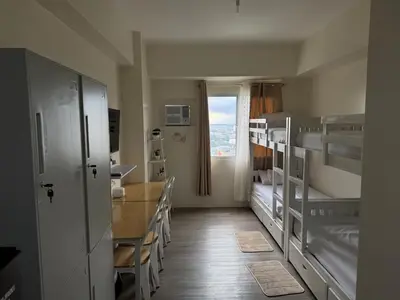 a room with two bunk beds and a window at Jac's Hide Out 5 in Manila