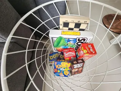 a shelf with snacks and a box on it at Cozy 1BR Corner with Panoramic City Skyline View in Manila