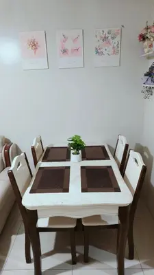 a dining room table and chairs with a plant on it at Shell Residences MOA - Josh staycation in Manila
