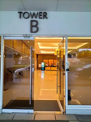 a view of the entrance to a tower b building at Shell Residences MOA - Josh staycation in Manila