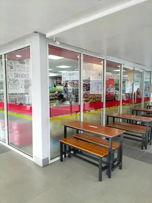 a store with benches in front of a store window at Shell Residences MOA - Josh staycation in Manila