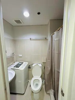 a small bathroom with a toilet and a sink at Shell Residences MOA - Josh staycation in Manila