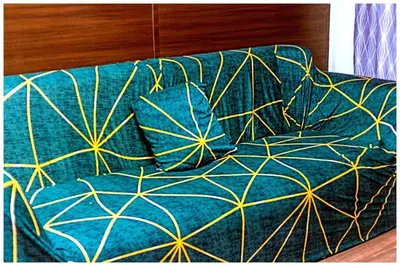 a couch with a blue and yellow blanket on it at 2 bedroom fantastic air condo 3649 swim gym surf 300 MB in Manila