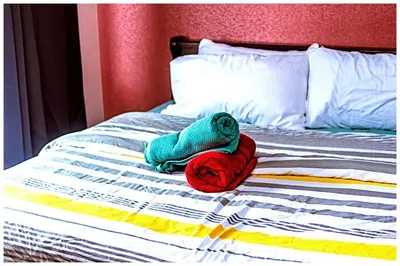a stuffed animal sitting on top of a bed at 2 bedroom fantastic air condo 3649 swim gym surf 300 MB in Manila
