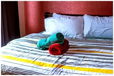 a stuffed animal sitting on top of a bed at 2 bedroom fantastic air condo 3649 swim gym surf 300 MB in Manila