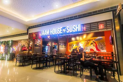 a restaurant with people sitting at tables in front of it at 2 bedroom fantastic air condo 3649 swim gym surf 300 MB in Manila