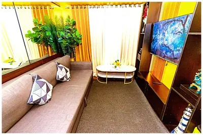 a living room with a couch and a table at 2 Bedroom Green Yellow luxury 5549 Makati 300Mb swim in Manila