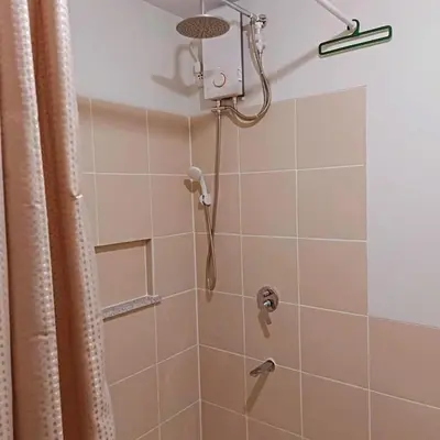 a shower with a shower head in a bathroom at Short stay near NAIA in Manila