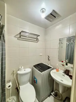 a small bathroom with a toilet and a sink at Resort-Style Living in Makati in Manila