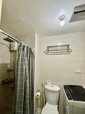 a small bathroom with a toilet and a shower at Resort-Style Living in Makati in Manila