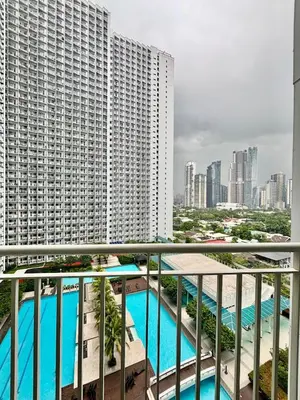a balcony with a view of a large building at Resort-Style Living in Makati in Manila