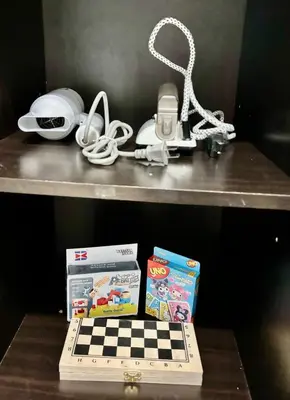 a shelf with a chessboard and other items on it at Resort-Style Living in Makati in Manila