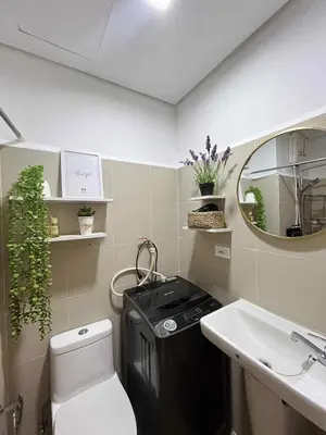 a bathroom with a toilet and a sink and a mirror at Casa Florencia at SDMC Coast Residences in Manila
