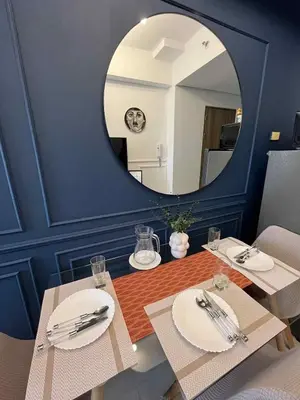 a dining room with a table and a mirror at Casa Florencia at SDMC Coast Residences in Manila