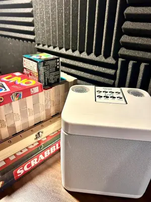 a white cooler sitting on the floor next to books at Cozy Studio near Nuvali, Enchanted Kingdom - Private Cinema with Netflix & Disney Plus with Free Pool Access in Silang
