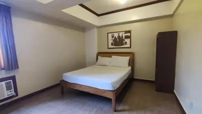 a small bedroom with a bed in a room at Peaceful 2BR Home in Paranaque Airport Area in Manila