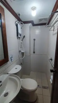 a small bathroom with a toilet and a sink at Peaceful 2BR Home in Paranaque Airport Area in Manila