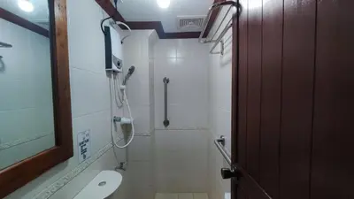 a bathroom with a shower and a toilet in it at Peaceful 2BR Home in Paranaque Airport Area in Manila