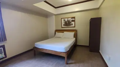 a small bedroom with a bed in a room at Peaceful 2BR Home in Paranaque Airport Area in Manila