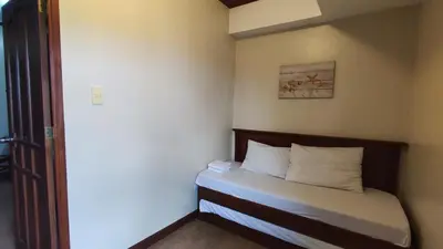 a small bed in a small room with acknowled at Peaceful 2BR Home in Paranaque Airport Area in Manila