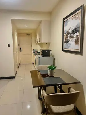 a kitchen and dining room with a table and chairs at Studio Condo by Sea Residences near MOA 03 in Manila