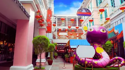 a purple frog sitting in a chair on a city street at Private Rooms in Historic Manila Chinatown in Manila