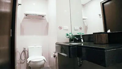 a bathroom with a black sink and a toilet at Private Rooms in Historic Manila Chinatown in Manila