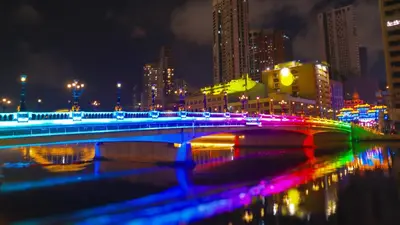 a bridge over a river in a city at night at Private Rooms in Historic Manila Chinatown in Manila