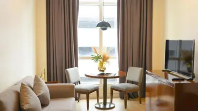 a living room with a couch and a table and a window at Private Rooms in Historic Manila Chinatown in Manila