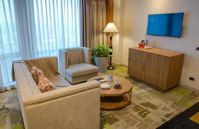 a living room with a couch and a chair at Business & Leisure Stay in Eastwood City in Manila
