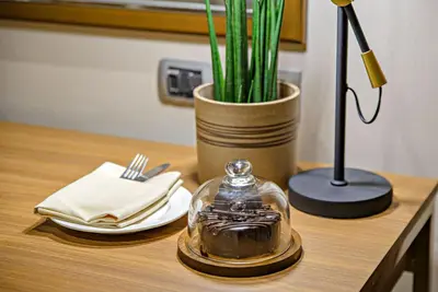 a table with a glass dish and a plant on it at Business & Leisure Stay in Eastwood City in Manila