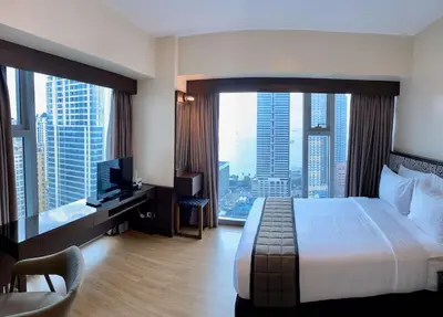 a hotel room with a bed and a large window at 8 Adriatico Condo beside Robinsons Mall Y1 in Manila