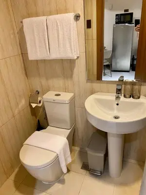 a bathroom with a toilet and a sink at 8 Adriatico Condo beside Robinsons Mall Y1 in Manila