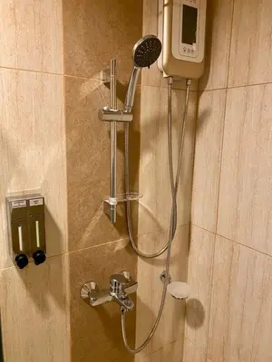 a shower in a bathroom with a shower at 8 Adriatico Condo beside Robinsons Mall Y1 in Manila