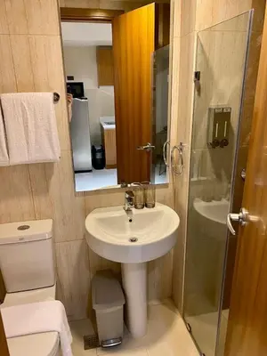 a small bathroom with a sink and a shower at 8 Adriatico Condo beside Robinsons Mall Y1 in Manila