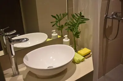 a bathroom with a white sink and a shower at Sea View older in Manila