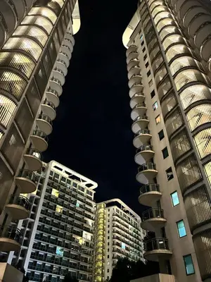 two tall buildings in a city at night at 15 Mins Away from NAIA Perfect for Staycation in Manila