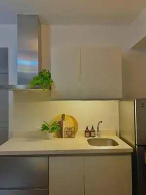 a kitchen with white cabinets and a sink at 15 Mins Away from NAIA Perfect for Staycation in Manila