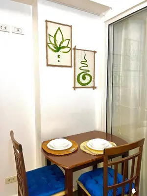 a dining room table and chairs with plates on it at 15 Mins Away from NAIA Perfect for Staycation in Manila