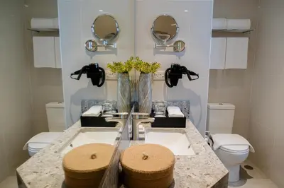 a bathroom with two sinks and two mirrors at Modern City Stay Near Manila Bay Attractions in Manila