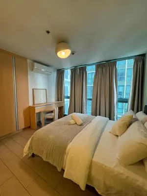 a bedroom with a large bed and a window at Modern Nordic 1BR Big Queen Bed Uptown BGC in Manila