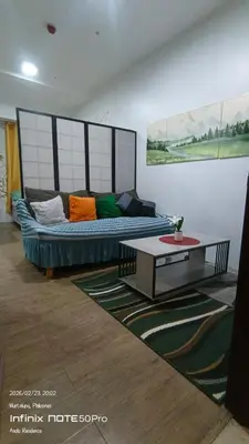 a living room with a couch and a coffee table at Alabang Staycation By Renz in Manila