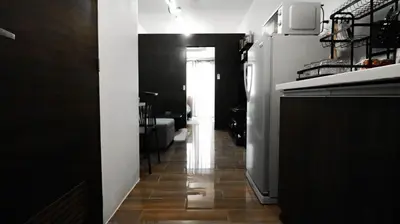 a hallway leading to a kitchen with a microwave at Smart Cozy Home Air Residences Makati 4125 in Manila