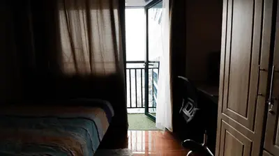 a room with a bed and a door with a balcony at Smart Cozy Home Air Residences Makati 4125 in Manila
