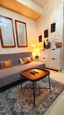 a living room with a couch and a coffee table at Urban Retreat at Shell Residences with Netflix 300mbps Wifi in Manila