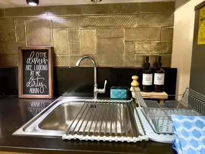 a kitchen counter with a sink and a sink at Urban Retreat at Shell Residences with Netflix 300mbps Wifi in Manila