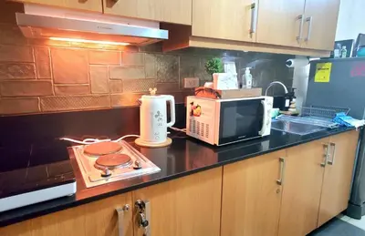 a kitchen counter with a microwave and a stove at Urban Retreat at Shell Residences with Netflix 300mbps Wifi in Manila