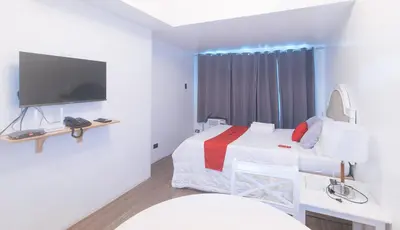 a hospital room with a bed and a tv at RedDoorz at MPT Suites in Manila